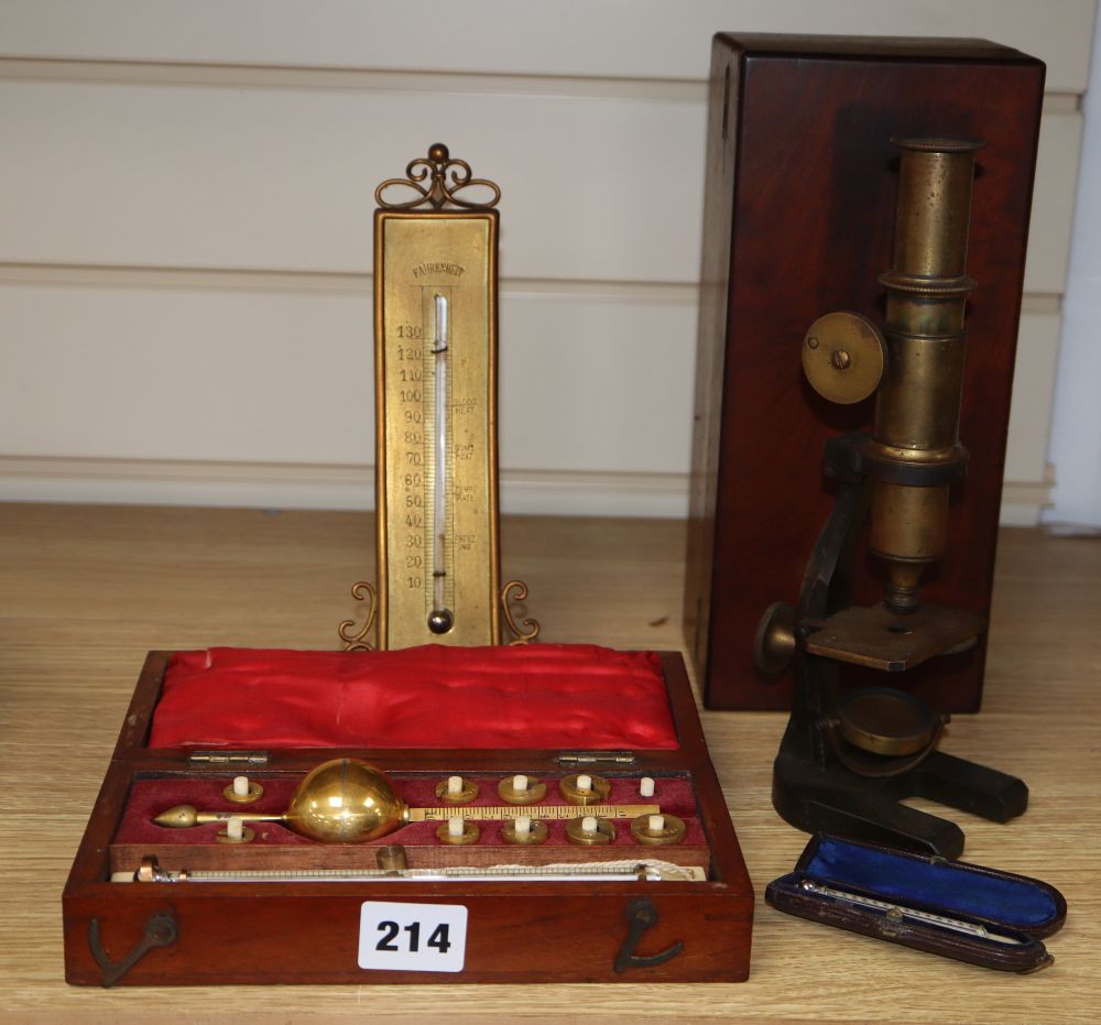 A cased microscope, a cased Sikes hydrometer and two thermometers